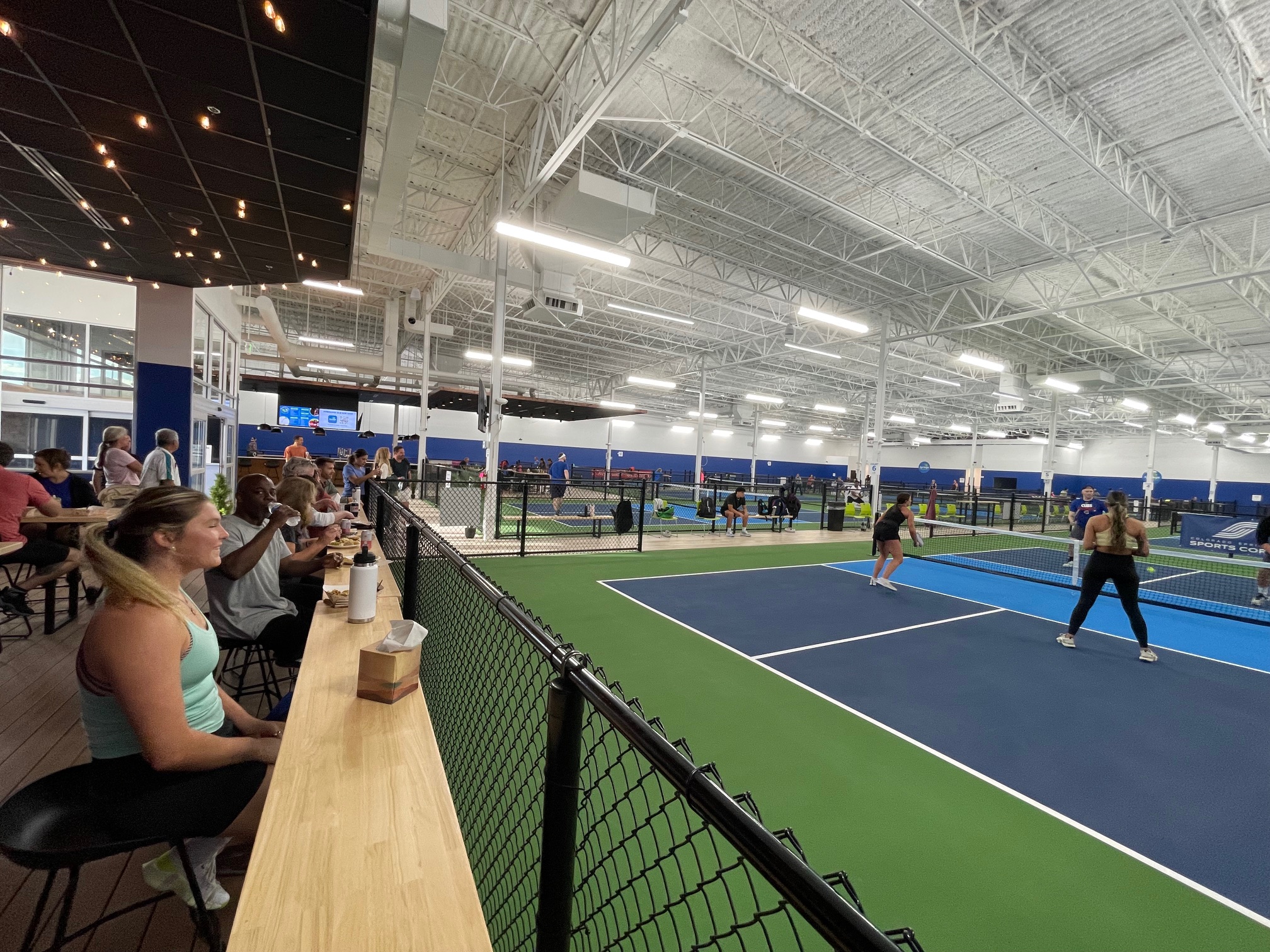 Springs Pickleball East player lounge overlooking courts